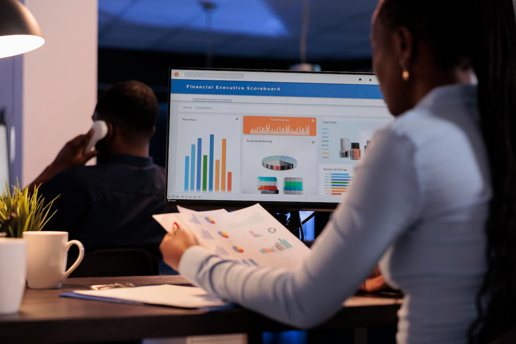 young business woman and Data analyst working with statistics charts on a computer