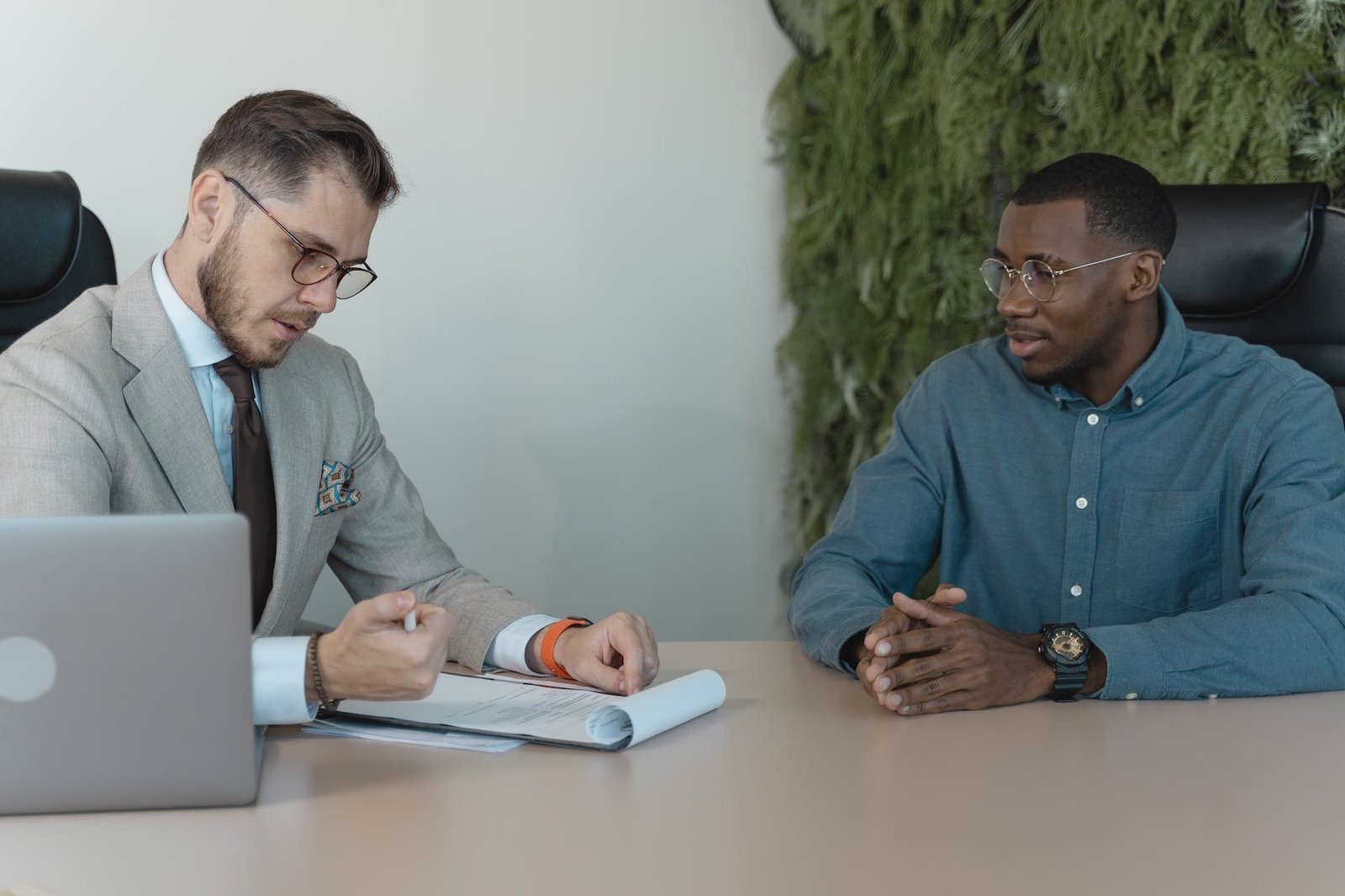 man in professional clothing reading a resume